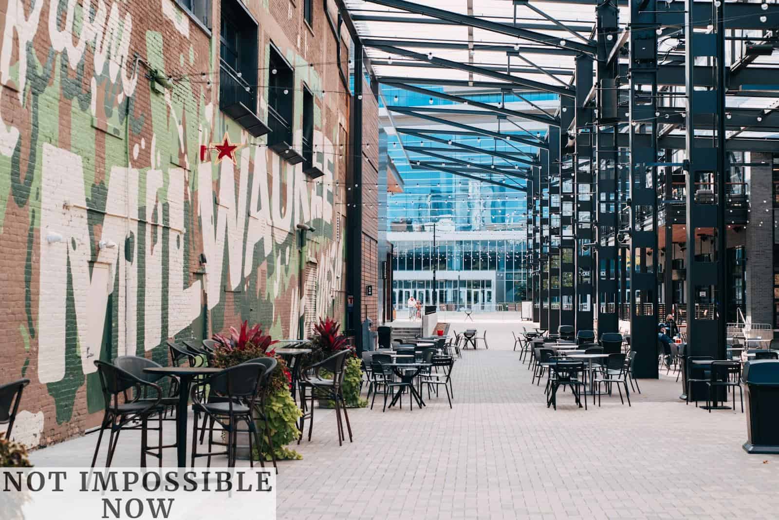 black metal chairs and tables outside building during daytime