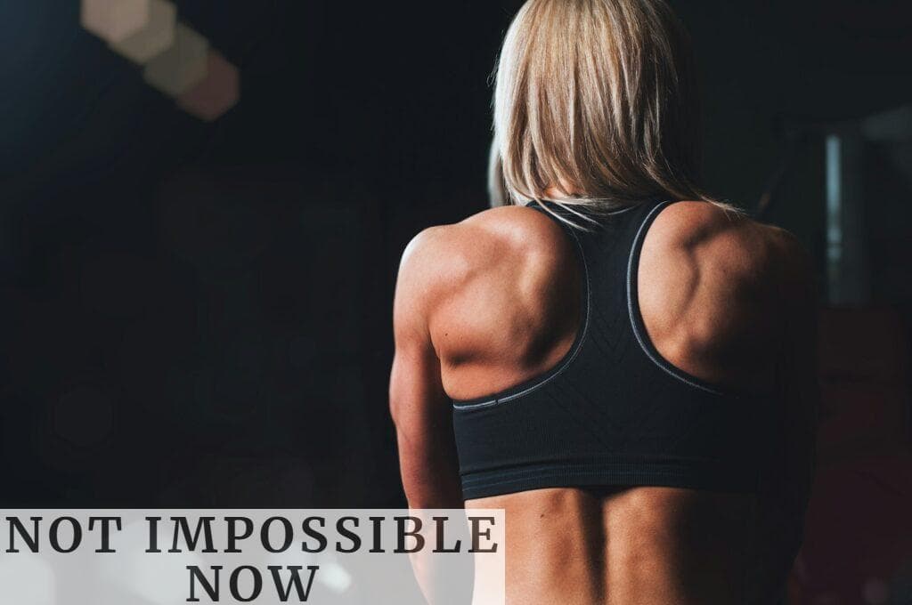 woman wearing black sports bra facing front selective focus photography