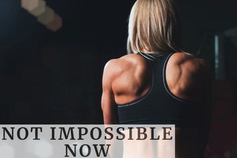 woman wearing black sports bra facing front selective focus photography