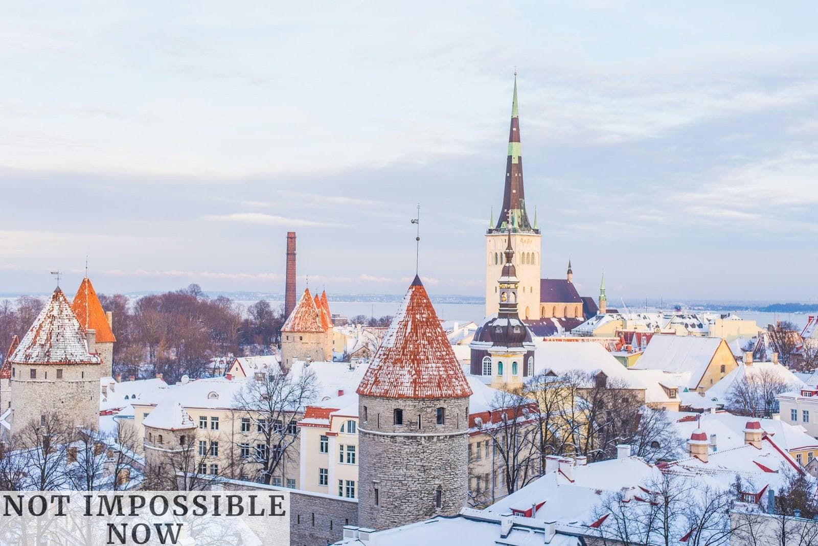 snow covered brown, white, and gray concrete castle under cloudy skies