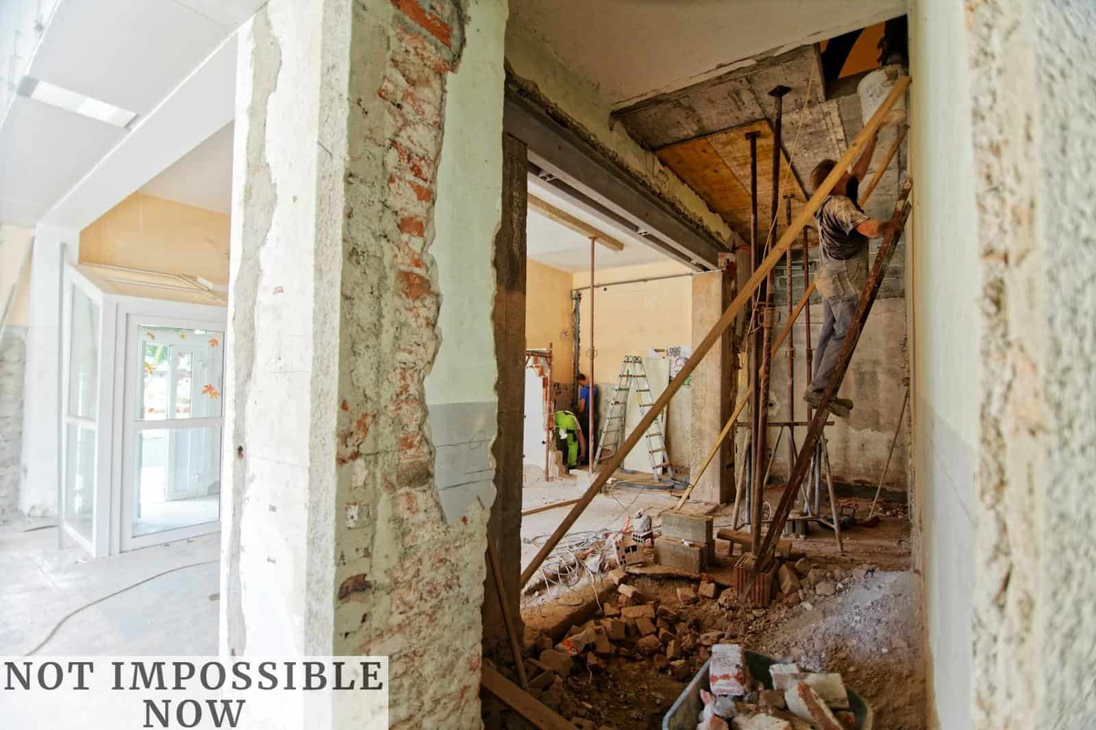 man climbing on ladder inside room