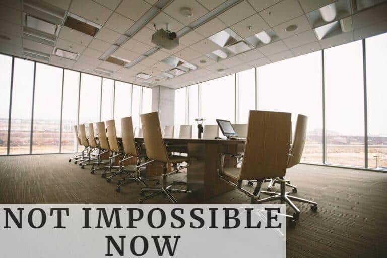 oval brown wooden conference table and chairs inside conference room